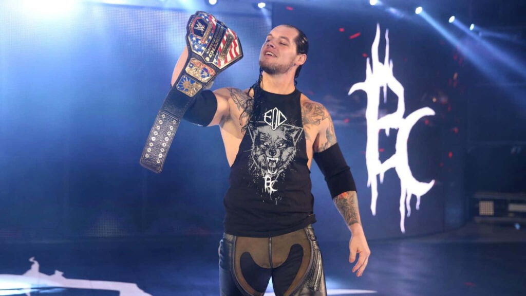 Baron Corbin holding championship belt in wrestling ring with custom logo background wallpaper