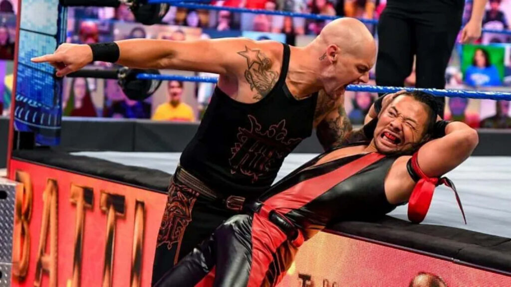 Baron Corbin overpowering Ricochet in intense WWE SmackDown wrestling match wallpaper background