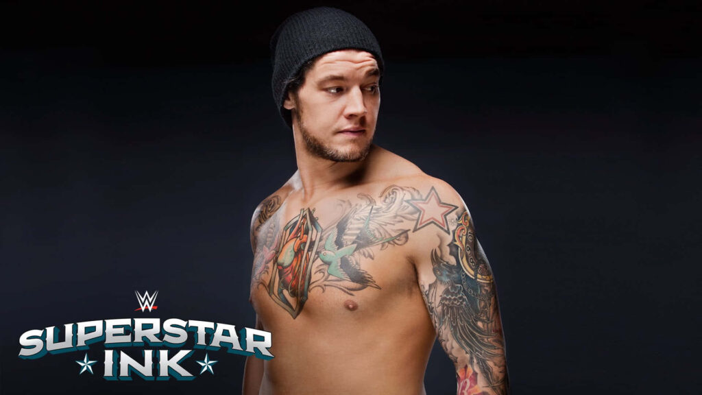Wrestler Baron Corbin shirtless showing colorful tattoos wearing black beanie WWE Superstar Ink logo Wallpaper