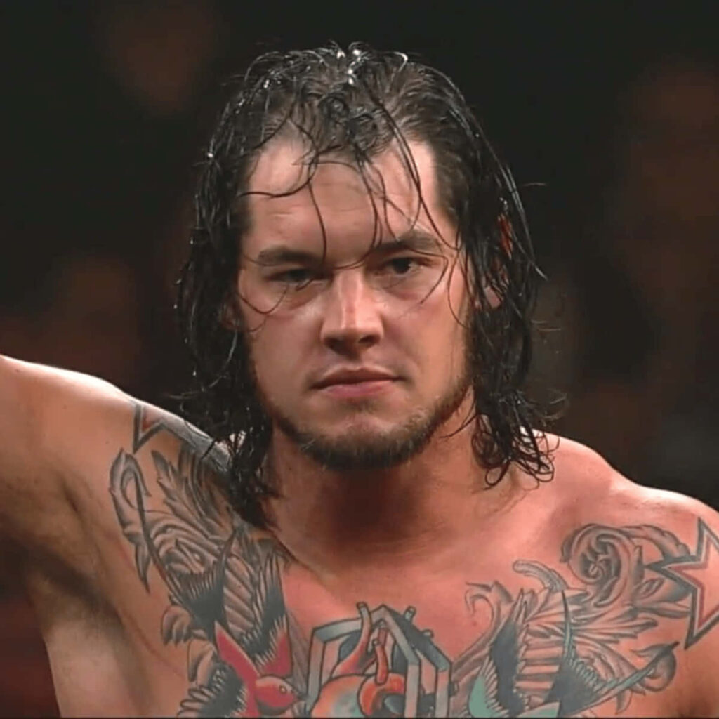 Baron Corbin in wrestling ring showing chest tattoos intense expression bold wrestler wallpaper