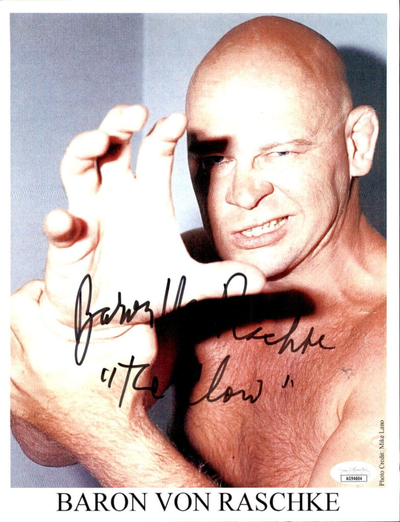 Autographed close-up portrait of wrestler Baron Von Raschke with intense claw gesture wallpaper