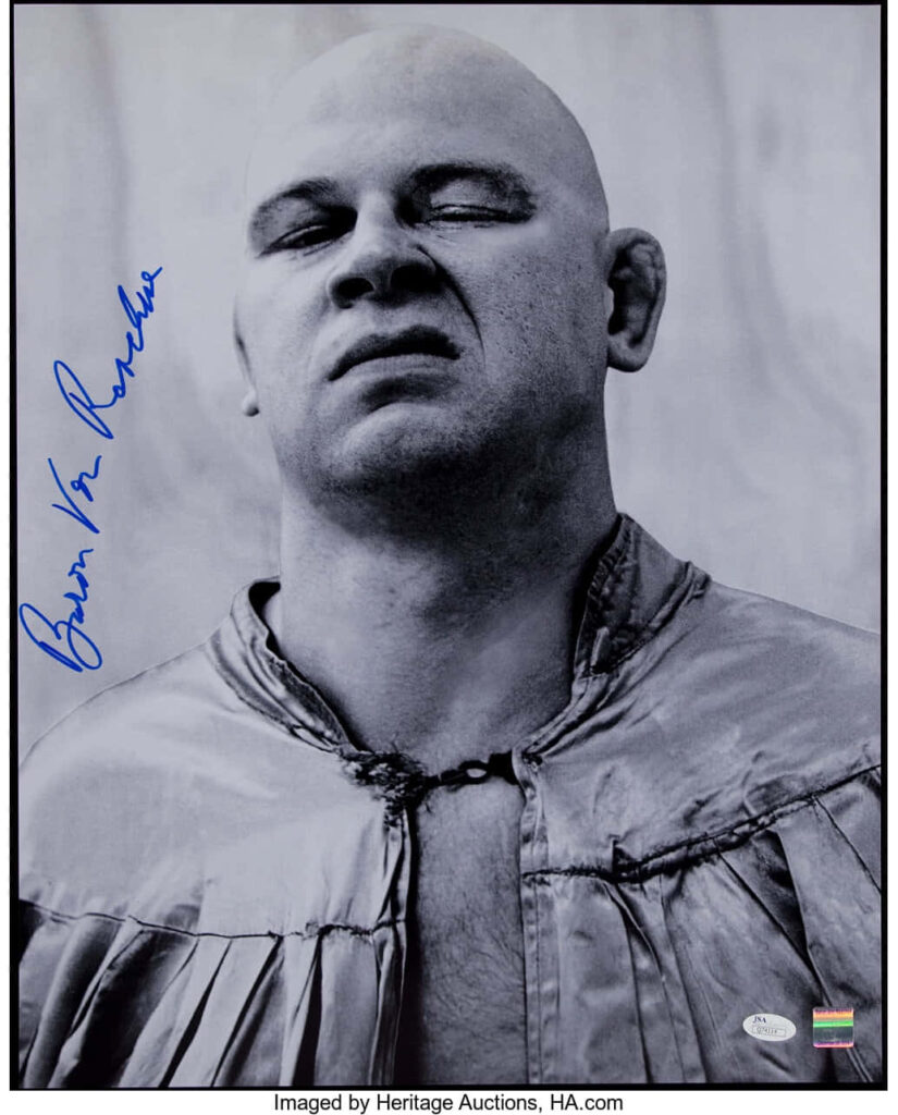 Grayscale autographed portrait of pro wrestler Baron Von Raschke with fierce expression wallpaper