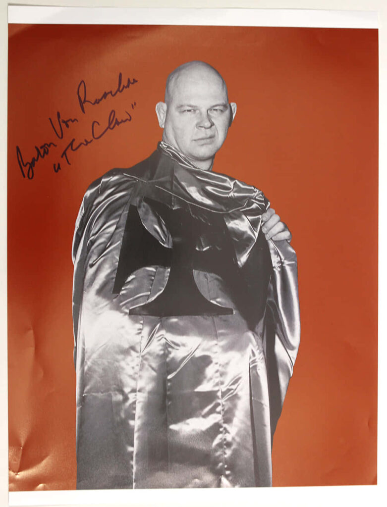 Signed portrait of wrestler Baron Von Raschke in signature cape iconic wrestling persona wallpaper