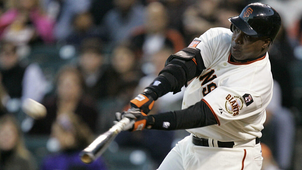 Barry Bonds powerful mid swing batting during baseball game dynamic sports wallpaper background