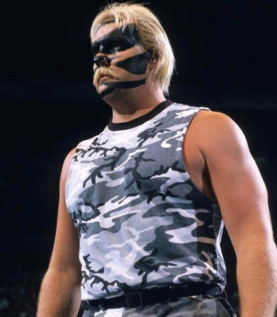 Barry Windham intense portrait with black face paint and camouflage tank top wallpaper background