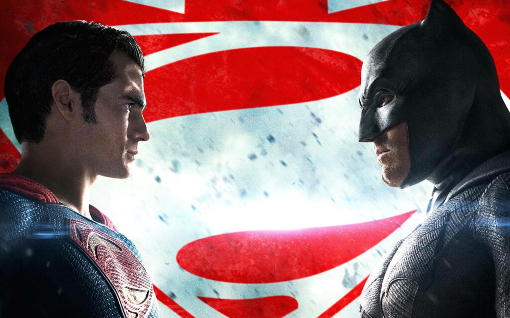Batman and Superman face off with intense expressions against dramatic Superman logo backdrop wallpaper