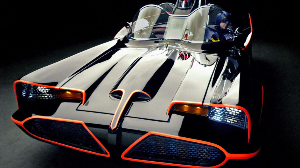 Outshining Shadows: The Iconic 1966 Batmobile With Luminous Orange Accents Wallpaper