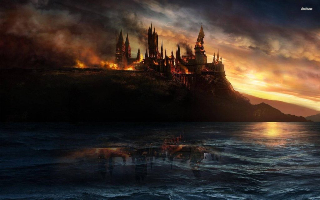 Battle of Hogwarts digital art wallpaper with flaming castle on cliff and fiery sea reflection
