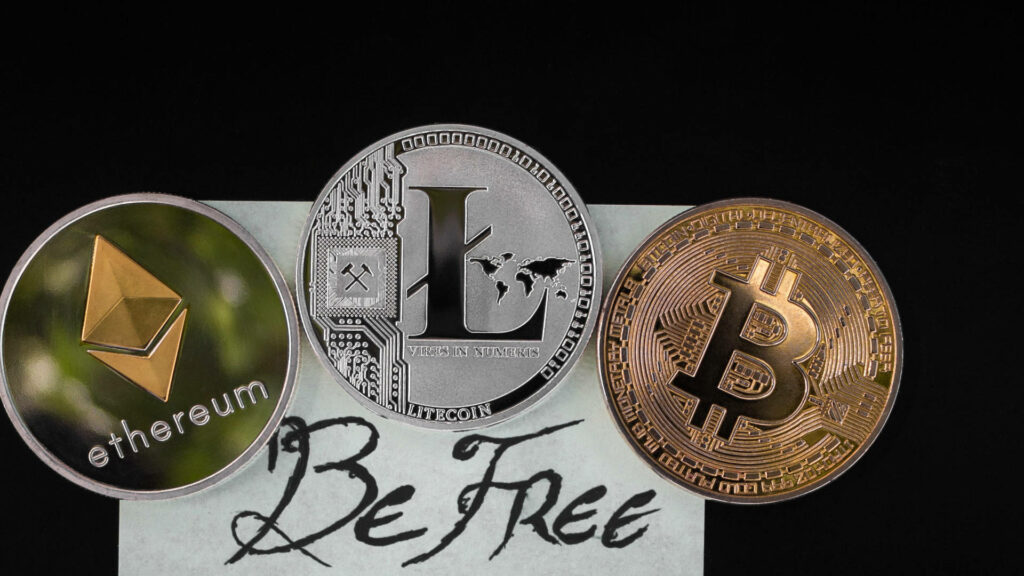 Digital coins Ethereum Litecoin Bitcoin with Be Free text on dark background cryptocurrency wallpaper