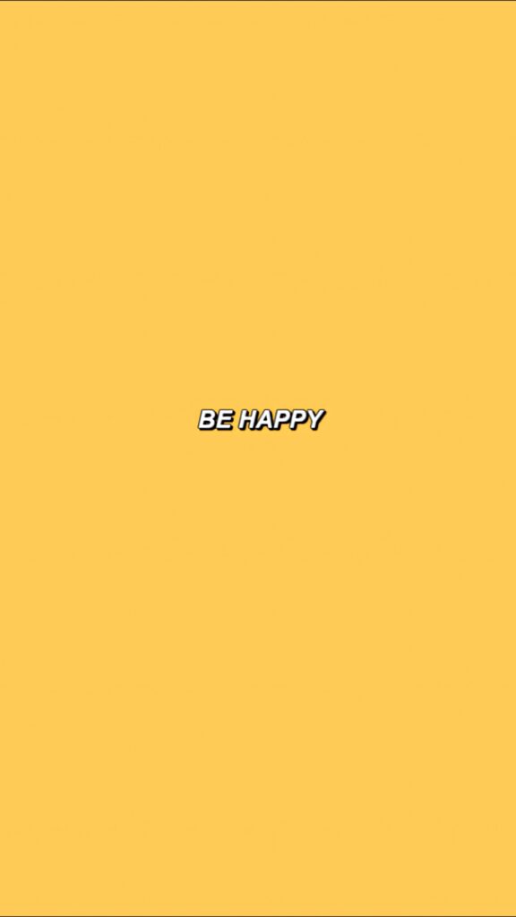 Cheerful yellow wallpaper with bold white Be Happy text uplifting positive background design