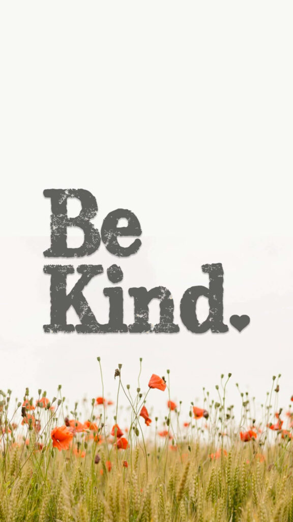 Serene flower field wallpaper with bold Be Kind message uplifting peaceful nature scene
