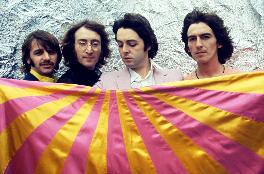 Beatles Wallpaper: Iconic Style with Pink & Yellow Flag Background