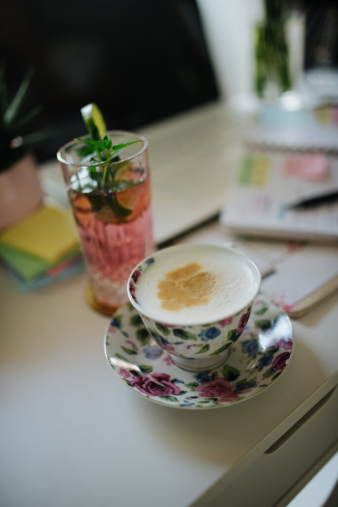 Elegant Cappuccino in Floral Cup: A Stylish Wallpaper Background