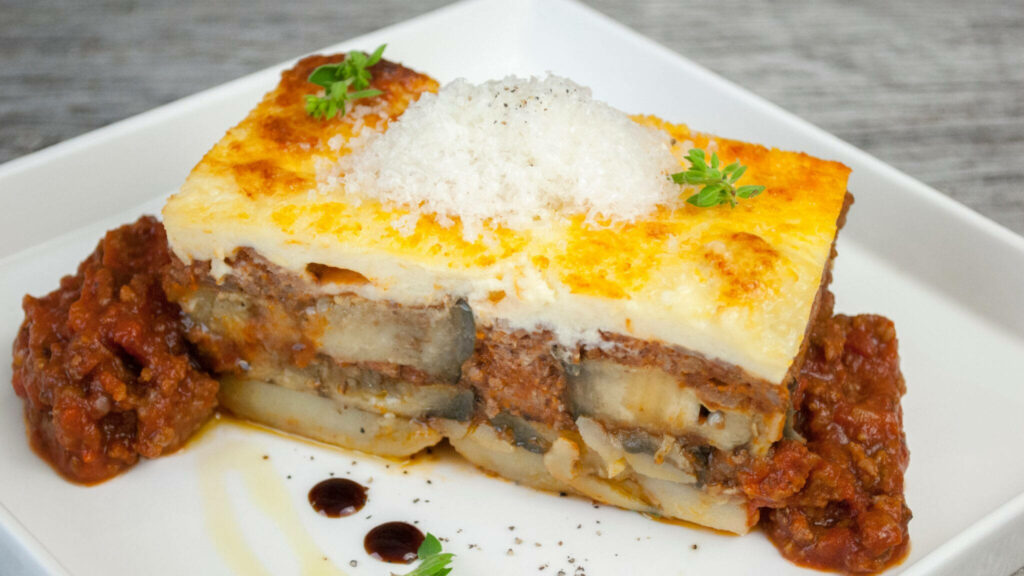 Delicious Moussaka Slice on Square Plate - Gourmet Wallpaper Background
