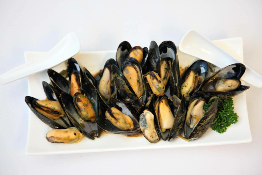 Elegant Mussels on White Plate - Culinary Wallpaper Background