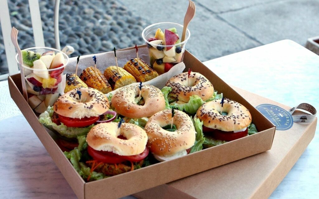 Vibrant Sandwiches & Fresh Fruits: Delicious Meal Wallpaper Background