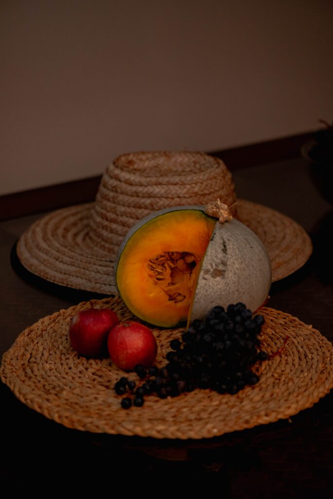 Charming Still Life Wallpaper: Pumpkins, Apples, Grapes & Straw Hat