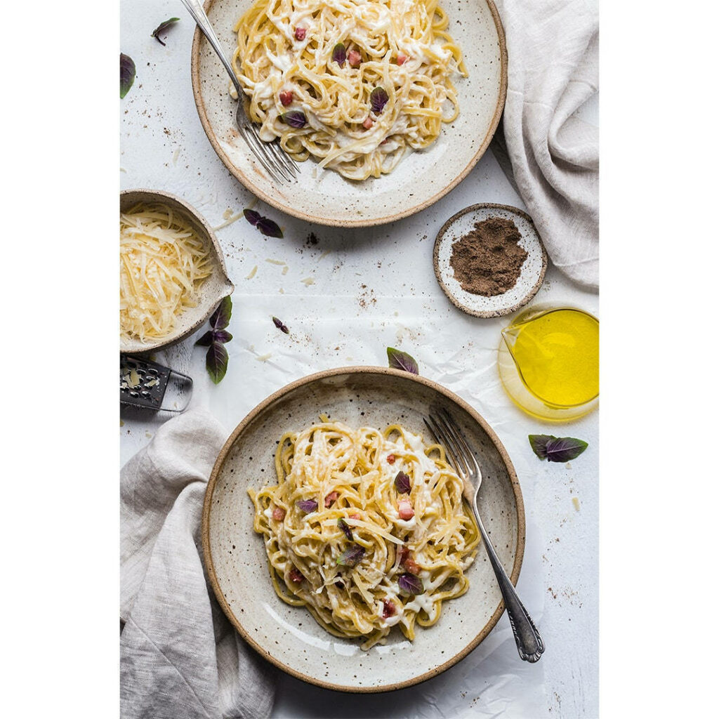 Delectable Pasta Wallpaper: Creamy Dishes on Rustic Plates