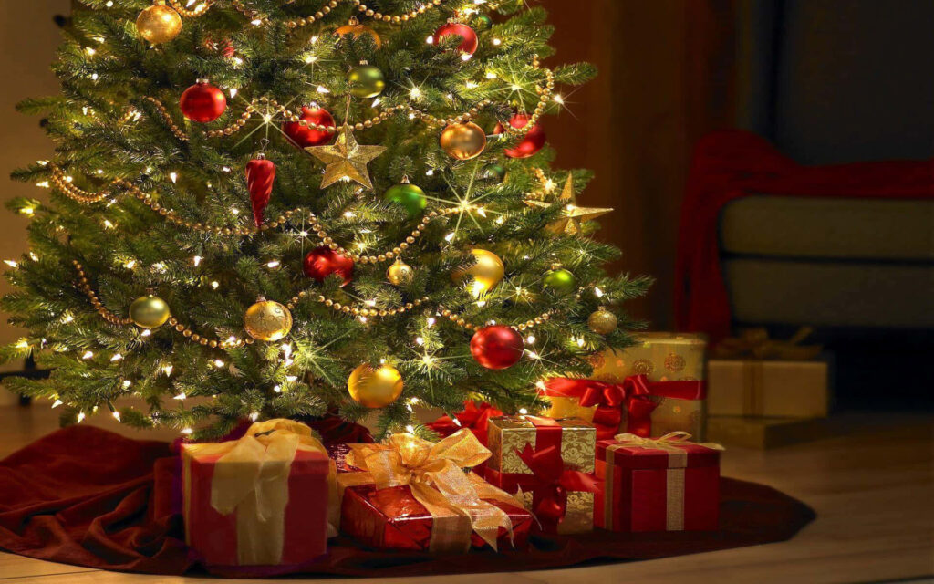 Stunning Christmas Tree with Sparkling Lights and Festive Gifts Wallpaper