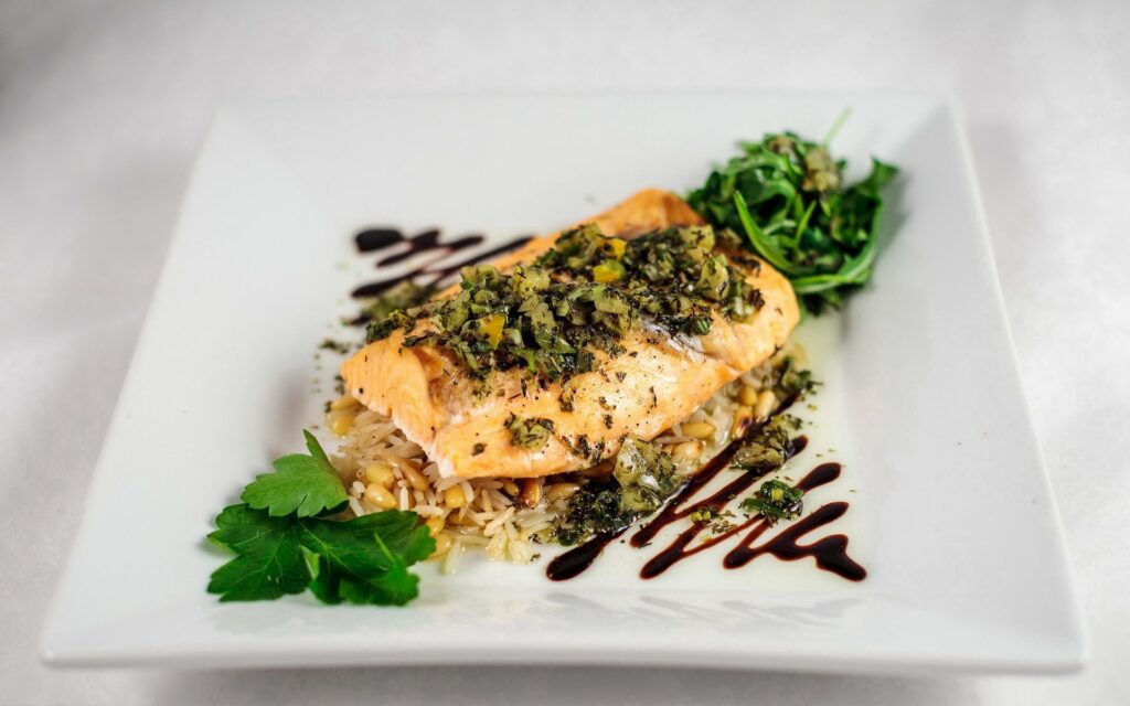 Elegant Fish Fillet Dish: Herb-Seasoned with Rice & Fresh Greens Wallpaper