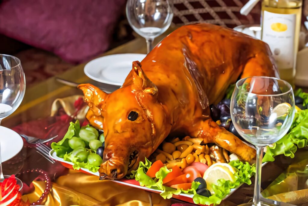 Elegant Baby Lechon Dish on Formal Table: Fresh Veggies & Wallpaper