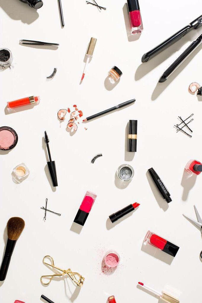Beauty Bliss: A Captivating Collage of Makeup Must-Haves in an Artistic Products Background Wallpaper