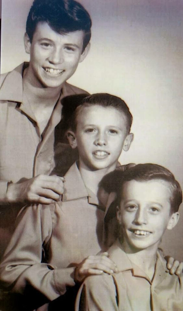 Classic Bee Gees wallpaper with youthful Barry Robin and Maurice Gibb portrait background