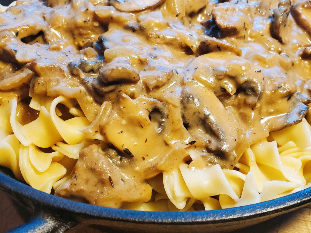 Delicious Beef Stroganoff Close-Up: Creamy Russian Dish Wallpaper