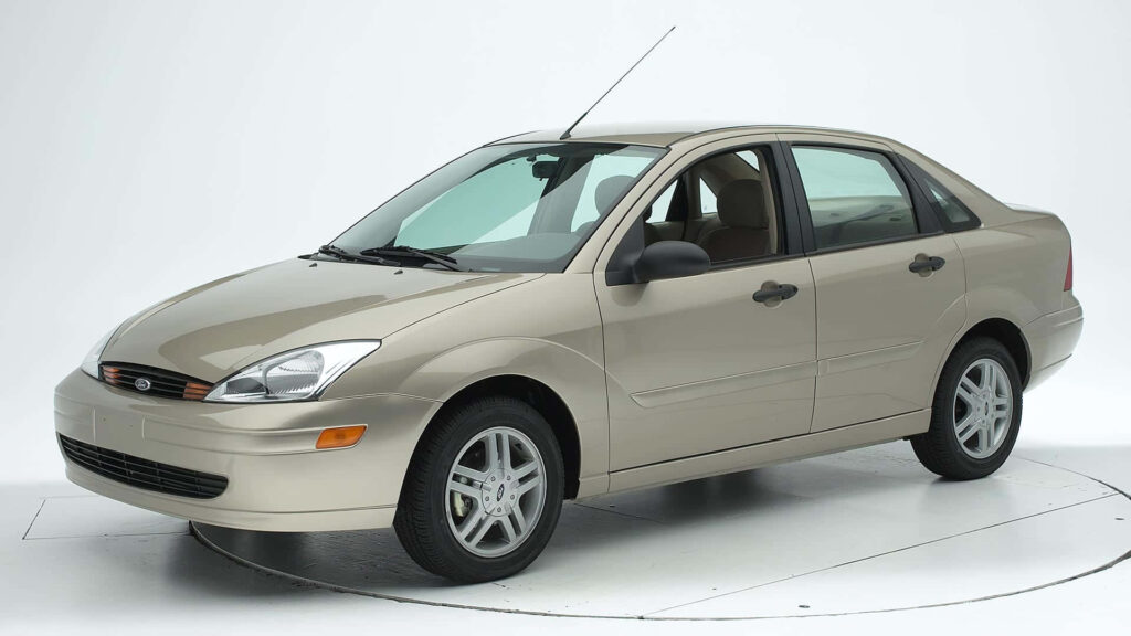 Beige Ford Focus sedan in studio with white background showcasing classic compact design Wallpaper