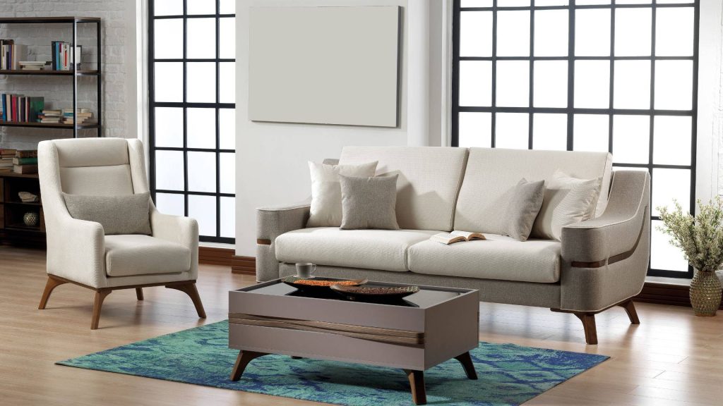 Beige living room set with minimalist sofa armchair modern table blue rug industrial windows Wallpaper