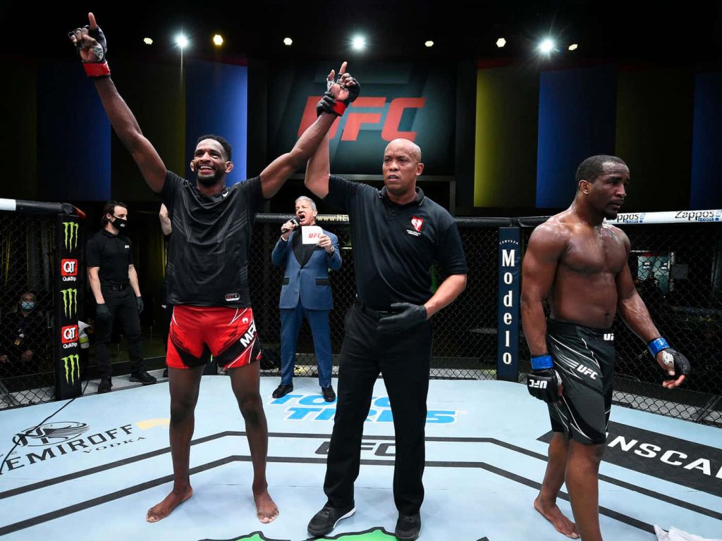 UFC fighter Belal Muhammad celebrates victory in Apex Octagon with referee Herb Dean signaling win Wallpaper