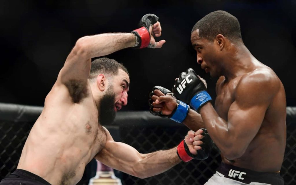 Belal Muhammad and Geoff Neal fierce MMA punch exchange inside UFC octagon action wallpaper background