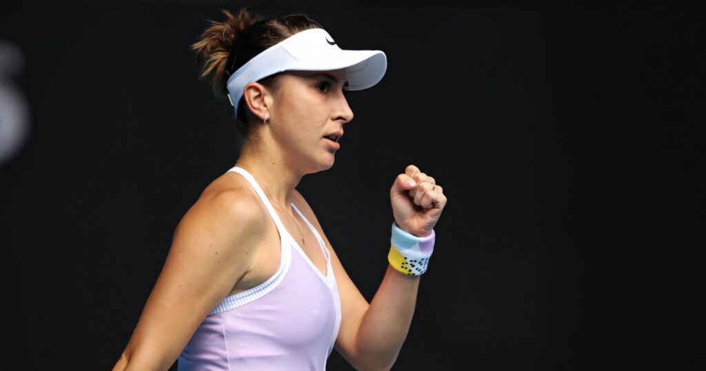 Belinda Bencic intense side view tennis match focused determined athlete with clenched fist gesture Wallpaper