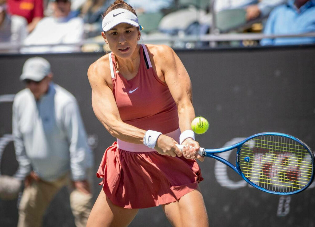 Belinda Bencic focused and powerful preparing to return shot in intense professional tennis match wallpaper