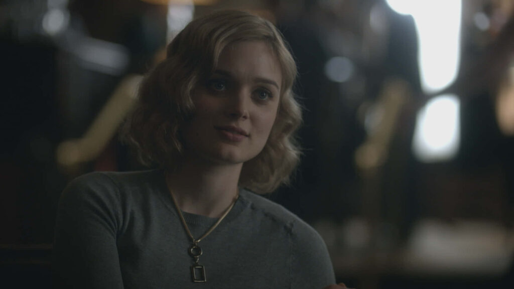 Bella Heathcote seated in soft light with thoughtful expression and gentle features wallpaper background