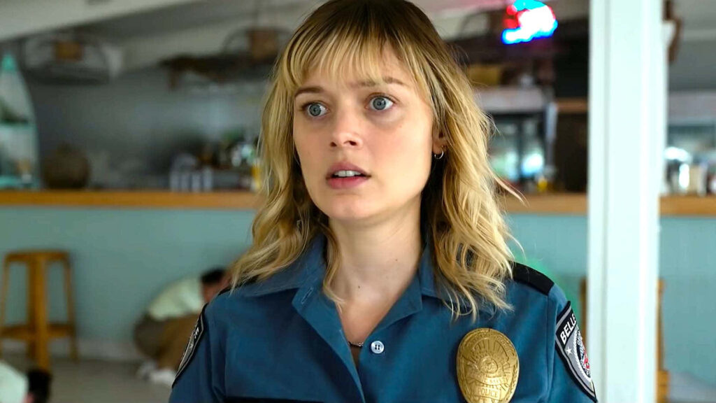 Bella Heathcote in police uniform with a serious expression intense dramatic wallpaper background