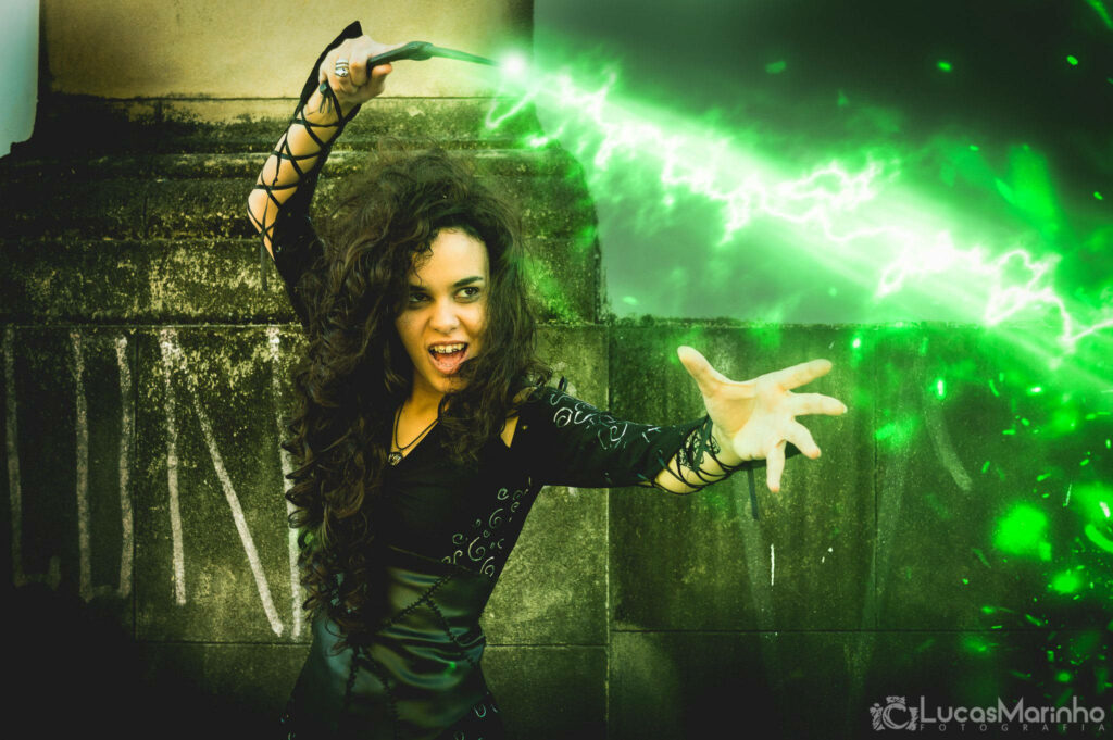 Bellatrix Lestrange casting vibrant green dark magic spell with fierce intense expression wallpaper