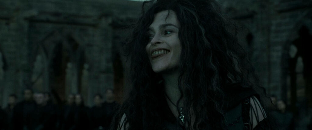 Bellatrix Lestrange grayscale wallpaper gothic castle ruins dark wild hair mischievous smile