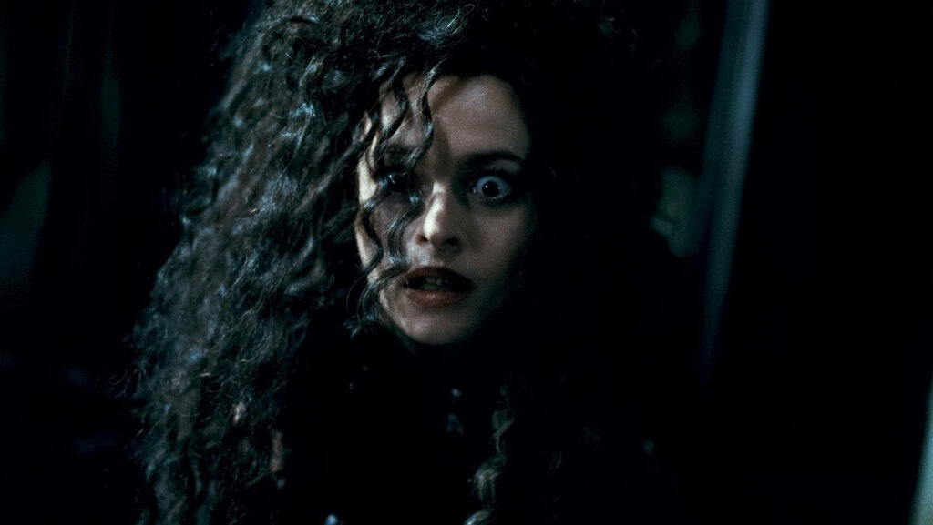 Bellatrix Lestrange shocked wide eyes wild dark hair intense expression dark background wallpaper