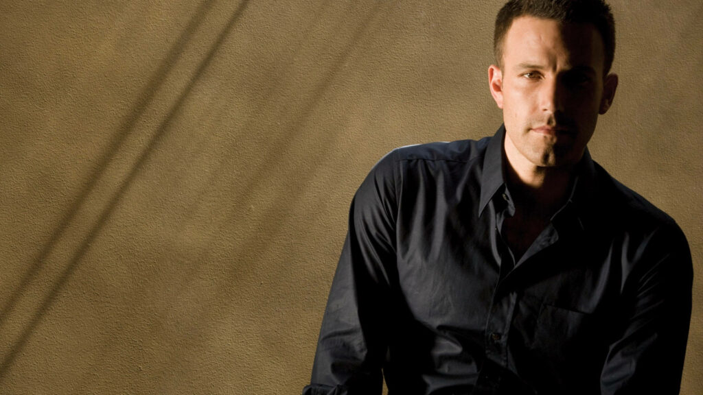 Ben Affleck in Black Shirt: Textured Beige Wallpaper Background
