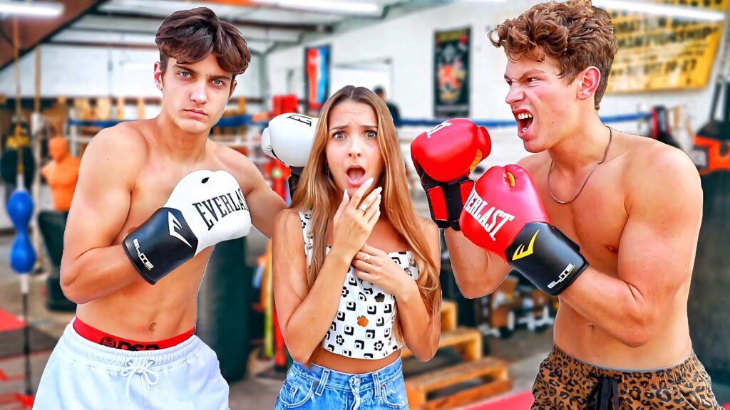 Ben Azelart boxing gloves faceoff with opponent surprised girl between them in gym wallpaper