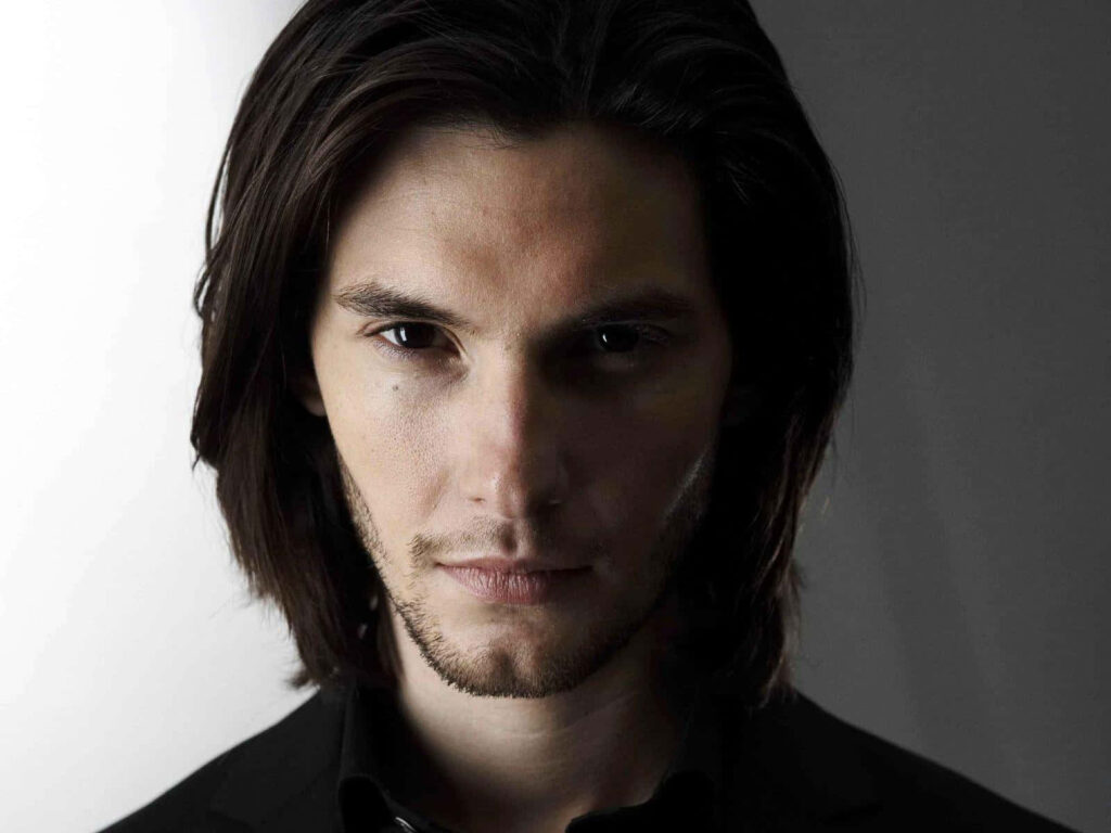 Portrait of actor Ben Barnes with intense gaze and striking features on plain background wallpaper
