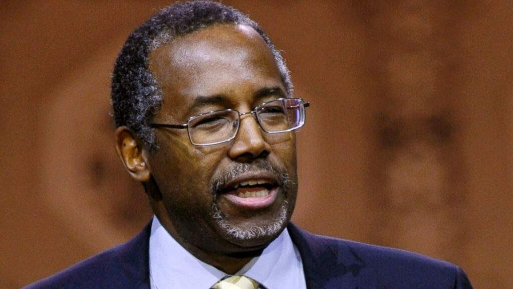 Close-up of Ben Carson with thoughtful expression and composed demeanor on blurred background Wallpaper