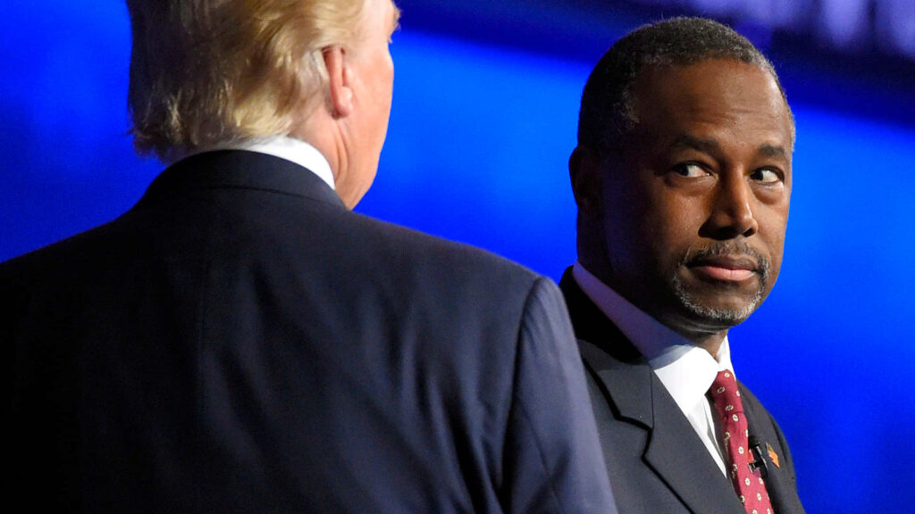 Ben Carson looking at Donald Trump at formal event with blue backdrop political leaders wallpaper