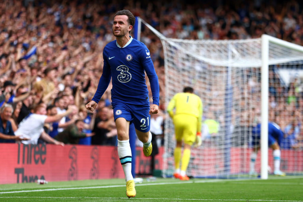Ben Chilwell celebrating goal sprint in Chelsea kit with cheering fans in stadium background Wallpaper
