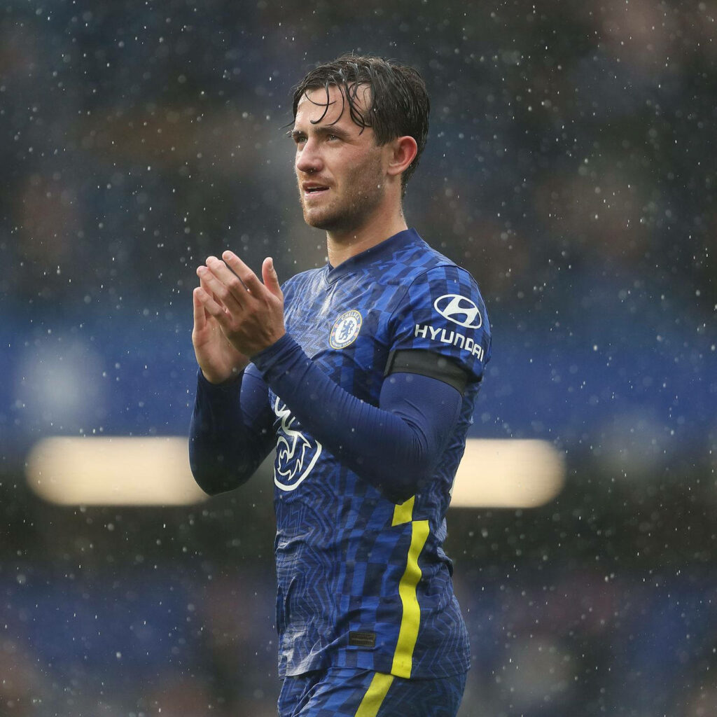 Ben Chilwell clapping in rain wearing Chelsea kit inspiring determination on football field wallpaper
