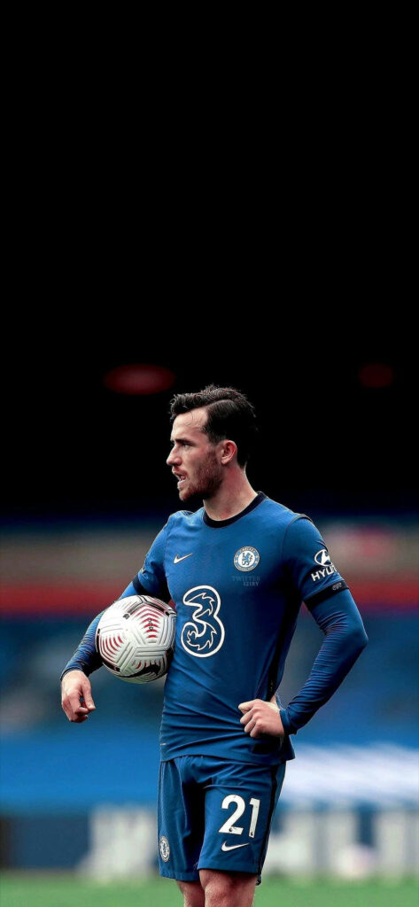 Ben Chilwell in Chelsea kit holding football on pitch ready for action wallpaper background