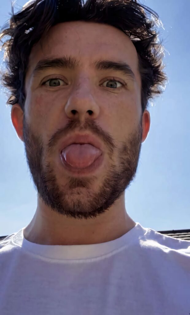 Ben Chilwell smiling playfully sticking tongue out clear blue sky fun lighthearted wallpaper background
