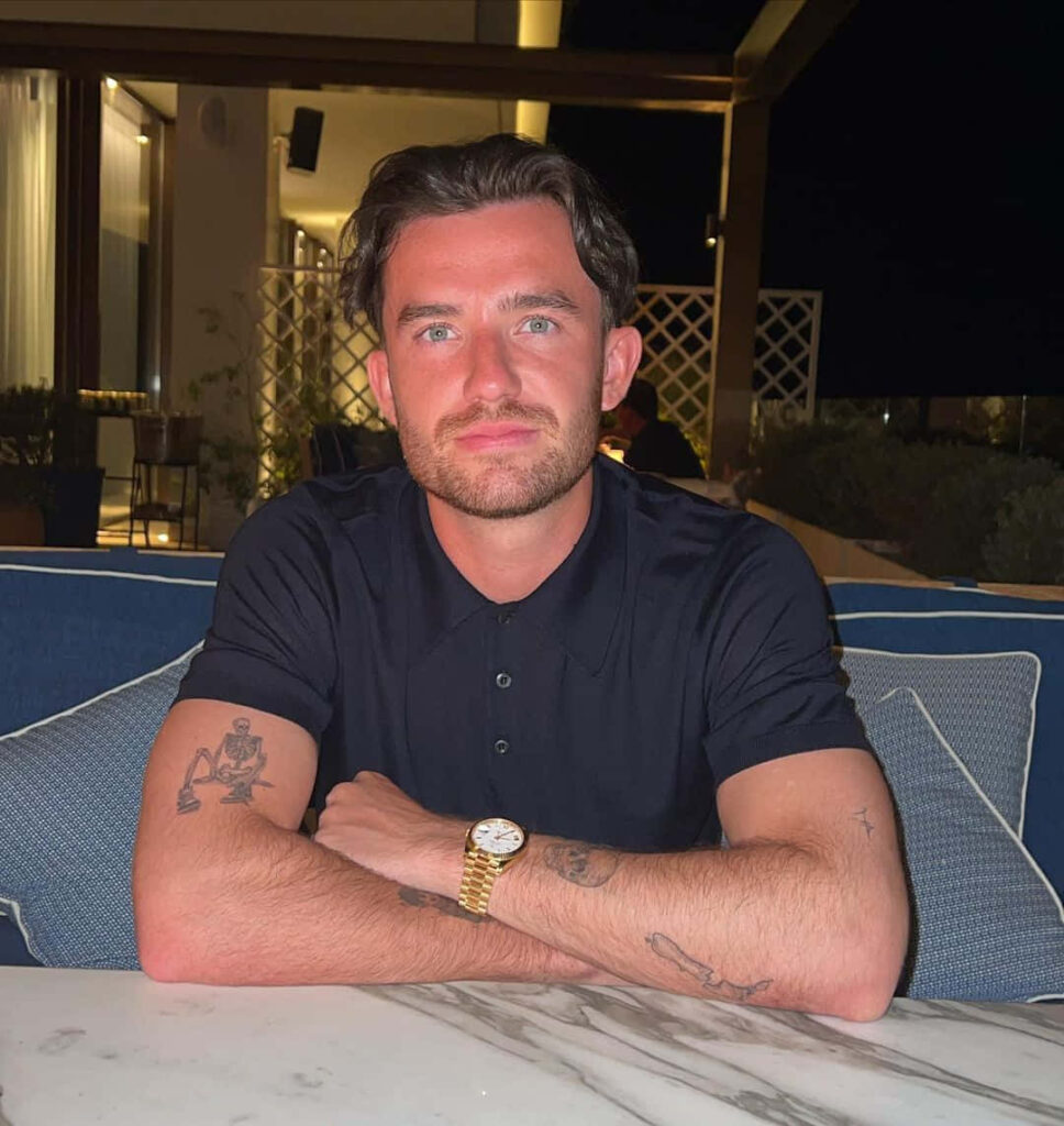 Football player Ben Chilwell sitting relaxed at dinner table wearing dark polo shirt wallpaper background
