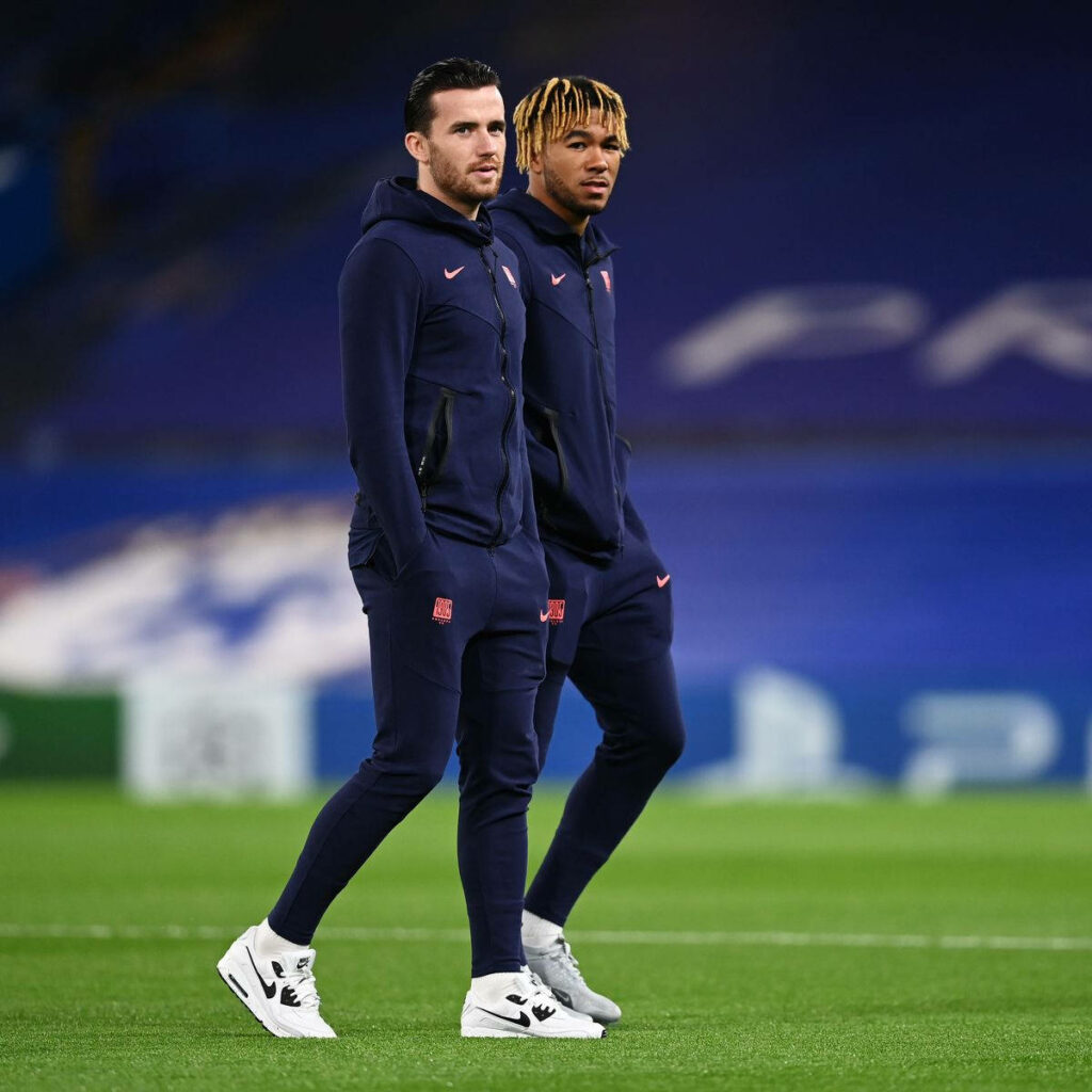 Ben Chilwell and Reece James walking on field in matching tracksuits stylish wallpaper background